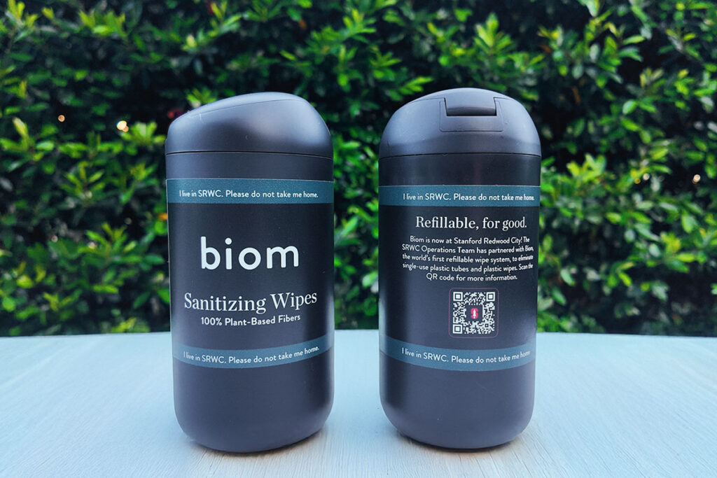 Two containers of "biom" sanitizing wipes.